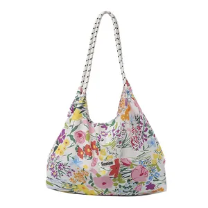 Floral canvas tote bag with sunshine label and thick rope handle on white background