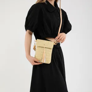 Stylish hand-woven straw crossbody bag with tassel detail and adjustable strap for women