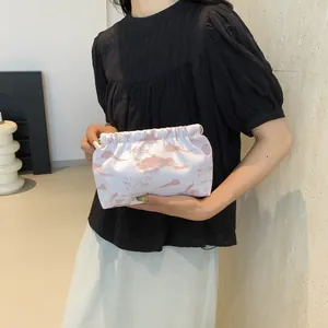 Détail d'une pochette nuage élégante à motif floral avec ouverture élastique plissée pour femme