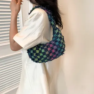 Colorful checkered woven hobo bag with fringe details and retro baguette style