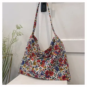 Detailed view of colorful floral pattern on large cotton tote bag with long straps