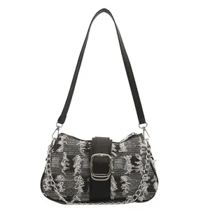 Classic black and white checkered tweed underarm bag with silver metal buckle and chain