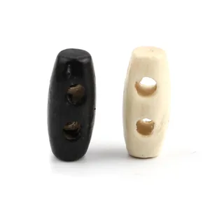 Botones de trenca ovalados en negro y crema para abrigos y suéteres con dos agujeros
