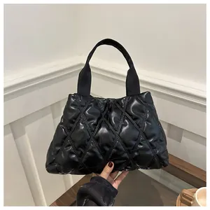 Chic black quilted tote bag with a glossy diamond pattern finish and wide strap
