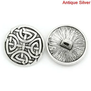 Detailed macro view of antique silver Celtic knot buttons showing front and back shank