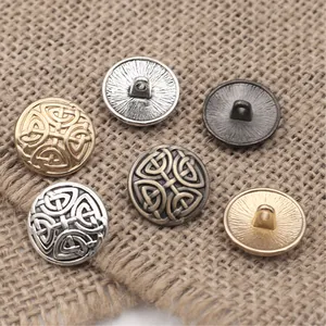 Detail of Celtic knot metal buttons in antique bronze and silver on burlap texture