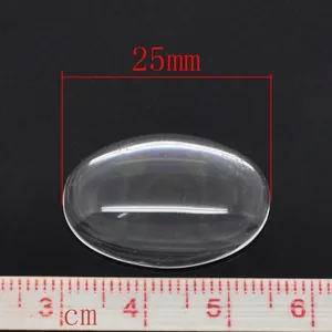 Transparent oval glass cabochon 25mm size measurement on a ruler for DIY jewelry