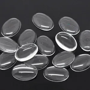 Clear oval glass cabochons for DIY jewelry making laid on professional black background