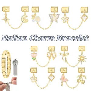 Dettaglio macro di maglie per bracciale italiano con ciondoli smaltati dorati a fiori e fiocchi