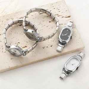 Detailed macro view of retro stainless steel modular watch bands on a textured stone surface
