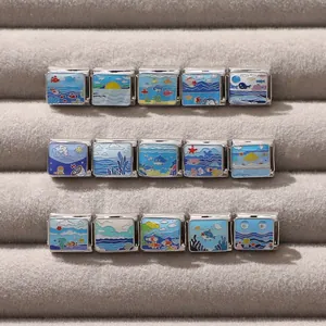 Detail of 15 modular stainless steel ocean charms with colorful enamel sea patterns