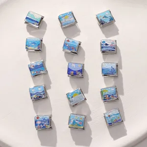 Macro shot of colorful enamel sea charms including dolphins and waves on stainless steel beads