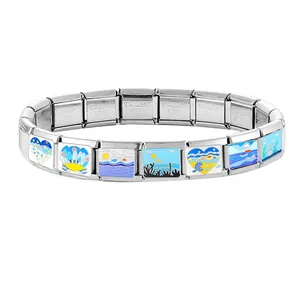 Macro view of ocean-themed enamel charms and polished stainless steel Italian bracelet