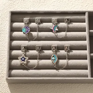 Details von italienischen Modul-Charms mit Muschel, Regenbogenstern und bösem Blick