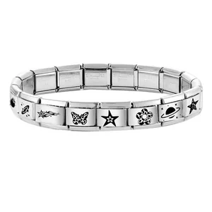 Detailed macro of modular stainless steel charm bracelet links with diverse motifs