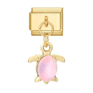 Italian charm bracelet module with golden metal sea turtle pendant and pink gemstone
