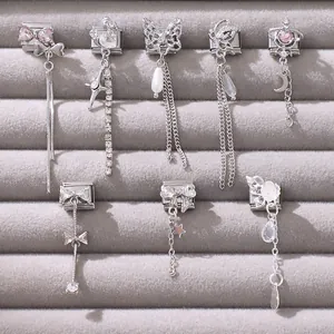 Detailed view of silver modular Italian charms with pink stones and butterfly pendants