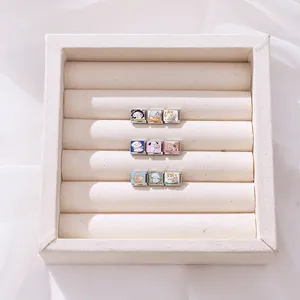 Detail of nine stainless steel Italian charms featuring cute enamel pets in a jewelry box