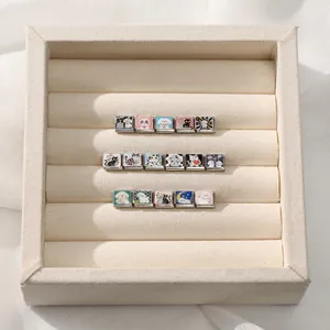 Detailed view of Italian style modular charms with colorful enamel cat and dog motifs