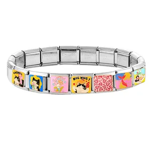 Macro detail of Italian charms bracelet with lucky cat links and stainless steel texture