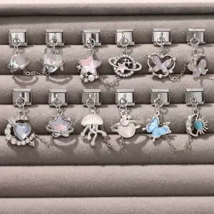 Macro view of modular Italian charms with crystal butterfly and planet designs