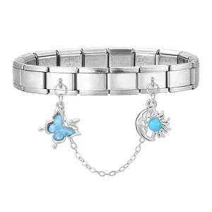 Detail of stainless steel charm bracelet with blue butterfly and moonstone pendants