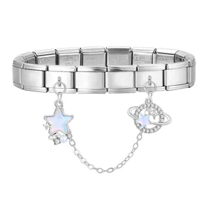 Detailed macro view of stainless steel charm bracelet with star and saturn pendants