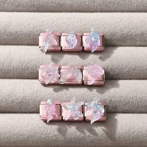 Macro view of ocean themed resin charm links with glitter in rose gold finish