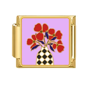 Italian charm bracelet module in gold with purple floral enamel pattern design