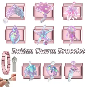 Detailed macro view of rose gold Italian charm links with glittery purple ocean motifs