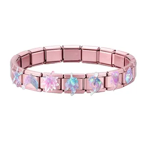 Close-up of rose gold Italian charm bracelet with holographic sea life icons