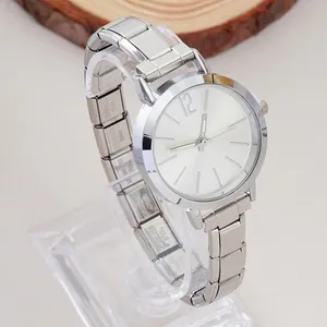 Close-up of silver stainless steel watch strap showing the material engraving on metal
