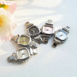 Detailed view of five minimalist square watches in silver stainless steel with varied dials