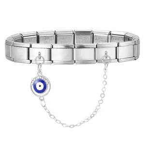 Detail of stainless steel Italian charm bracelet with evil eye pendant and safety chain