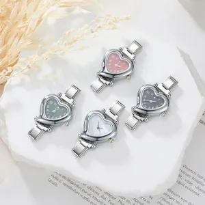 Detail of multi-color heart-shaped dials on polished silver metal modular watch straps