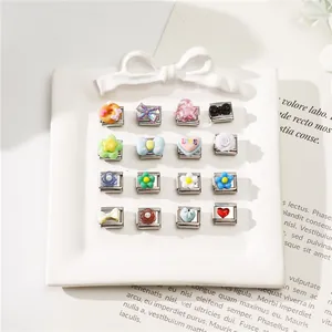 Close-up of DIY Italian style stainless steel bracelet charms with colorful motifs