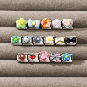 Macro view of assorted vintage Italian DIY charm modules for charm bracelets