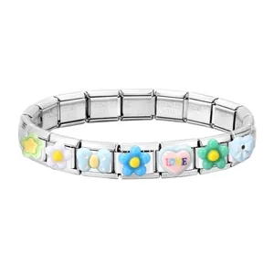 Macro shot of stainless steel Italian charm bracelet links with colorful flower and heart charms