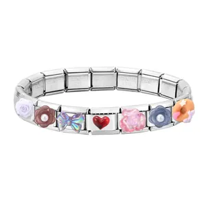 Detail of Italian charm bracelet with stainless steel links and colorful floral charms