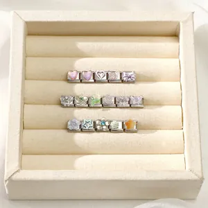 Detailed close-up of 9mm Italian charm links with resin hearts and floral motifs in a jewelry box