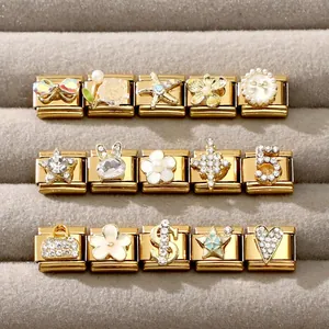 Macro view of gold Italian charm links with rhinestones, pearls, and rose floral details