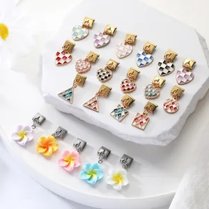 Detailed close-up of Italian charm links featuring colorful enamel checkerboard and flower patterns