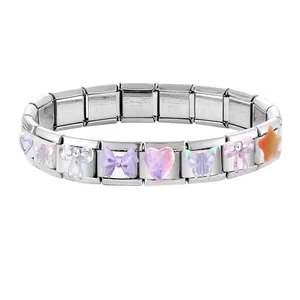 Close-up of stainless steel charms with butterfly, heart, and star shapes on the bracelet