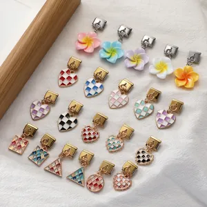Macro shot of Italian flower charm bracelets and colorful checkerboard enamel jewelry links
