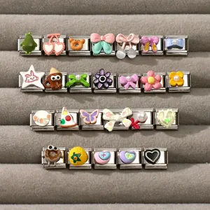 Macro view of modular Italian charms for DIY bracelets with floral and heart patterns