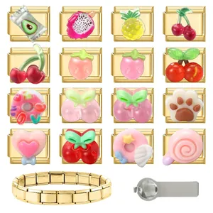 Macro view of modular gold-plated stainless steel charms with fruit and cartoon icons
