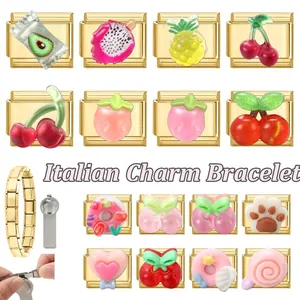 Detail of DIY Italian charm bracelet modules with gold stainless steel and fruit designs