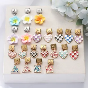 Collection of colorful enamel Italian charm links with floral and geometric patterns