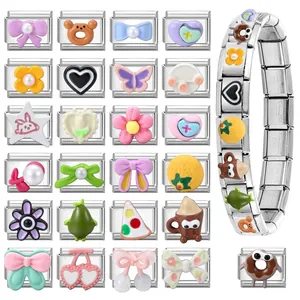 Macro view of various stainless steel charm modules and a linked Italian charm bracelet