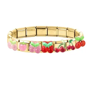 Macro view of modular stainless steel bracelet with colorful 3D enamel fruit charms
